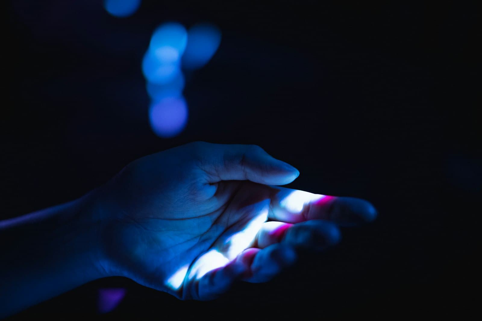 Open hand holding a glowing network of people, with one candidate selected