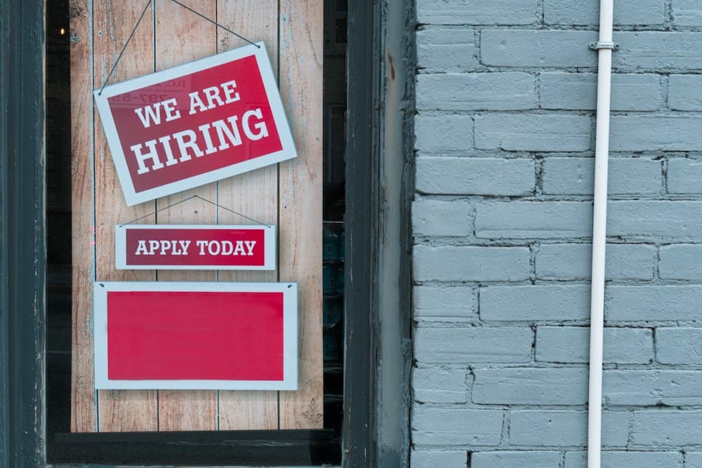 “We are hiring — apply today” sign
