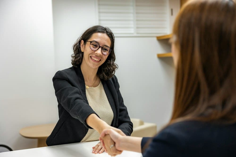 New hire shaking hands with a recruiter